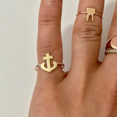 The anchor ring is composed of 14K solid gold and beautifully set onto a complementary matching 14K solid gold band. The perfect addition to your ring collection! Anchor Dimensions: approximately 9mm (w) x 11mm (h) Band Thickness: approximately 1.4mm Metal Finish: High Shine Polish This design is available in Rose, White and Yellow 14K Gold Please note that this item takes about 3 to 5 business days for production, prior to shipping. This item is proudly made in USA. *This piece comes in a Nana Bow Tie Ring, Tie Ring, Anchor Rings, Solid Gold Band, The Anchor, Ring Collection, Fine Jewelry Designers, Bride Bridal, Ring Collections