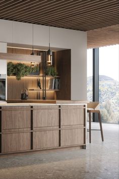 a modern kitchen with wooden cabinets and counter tops, along with a large window that looks out onto the mountains