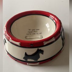 a red and white bowl with a black dog on the bottom that says if you can read this, refill or else