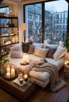 a living room filled with lots of furniture and candles