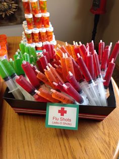 a box filled with lots of different types of toothbrushes on top of a wooden table