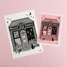 two stickers on a pink background one has a shop and the other has a cat