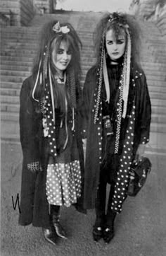 two women dressed in costumes standing next to each other