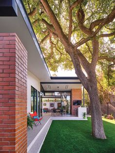 an outdoor living area with grass and trees