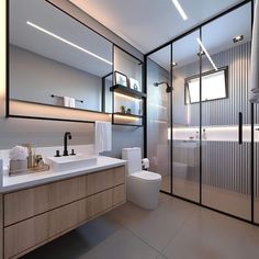 a bathroom with a toilet, sink, and shower stall is shown in this image