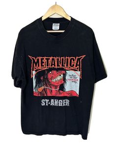 a black t - shirt with the words metallicica on it