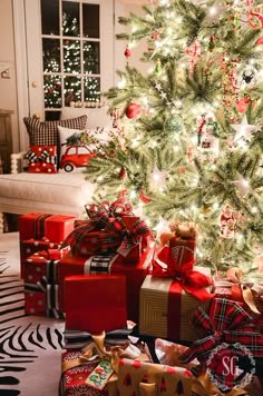 a christmas tree with presents under it