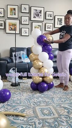 a woman standing next to a bunch of balloons