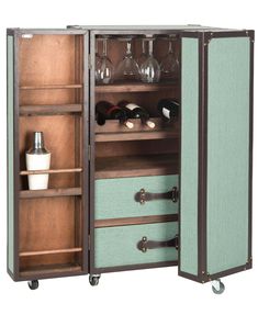 an open cabinet with wine glasses and bottles in it