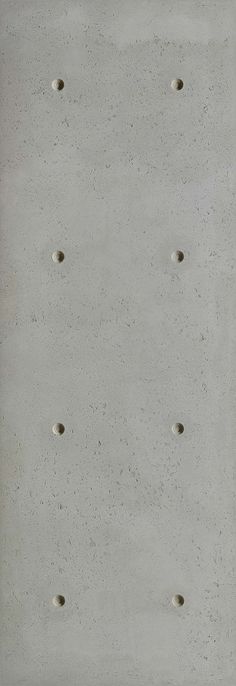 a cement wall with holes in it