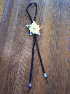 a star shaped wand laying on top of a wooden floor