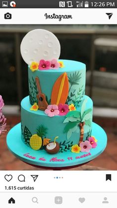 a three tiered cake decorated with flowers and surfboards on the top is blue