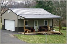 a small house with a metal roof and covered porch