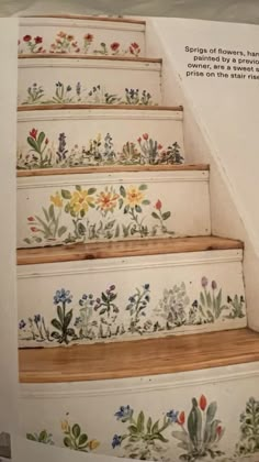 the stairs are painted with flowers and plants on them, as well as an advertise