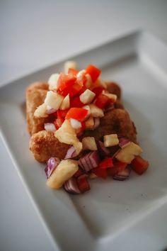 a white plate topped with meat and veggies on top of it's side