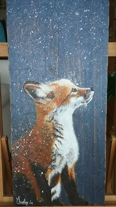 a painting of a fox sitting on top of a wooden easel