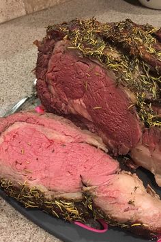 sliced roast beef with herbs and seasoning on a cutting board