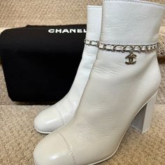 Chanel Calfskin White Ankle Boots With Cc Chain. These Were Bought And Worn Once For A Couple Of Hours On The Same Day. The Only Sign Of Wear Is Discoloration On The Sole From The Street! They Still Come In Original Packaging With Dust Bags. European Size 39. Chanel Ankle Boots, Shoes Chanel, Chanel Boots, White Ankle Boots, Chanel Shoes, Bootie Boots, Calf Skin, Dust Bag, Ankle Boots