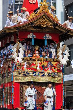 men in traditional chinese garb perform on top of a float