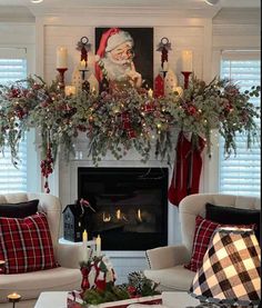 a living room filled with furniture and a fire place covered in christmas decorations on top of a mantel