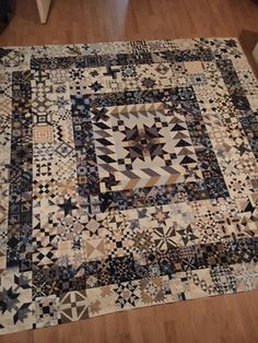 a large patchwork quilt on the floor