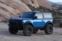 a blue truck is parked in the desert