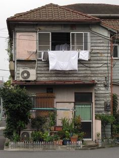 an old house with clothes hanging out to dry