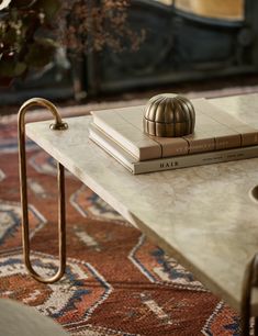 a table with two books on top of it and a candle holder next to it