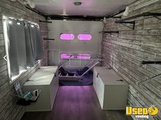 the inside of a vehicle with purple lights and wood flooring on the side wall