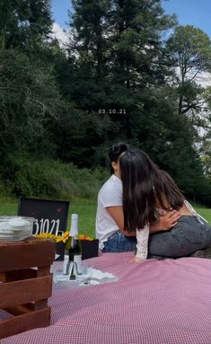 two people are sitting at a picnic table