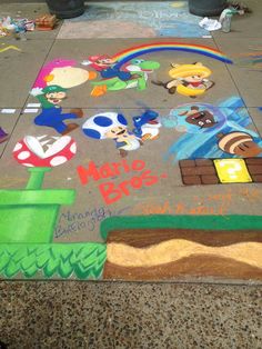 the sidewalk has been decorated with various cartoon characters