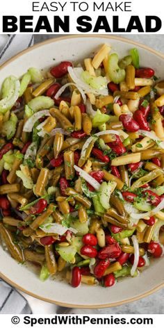 a white bowl filled with beans, onions and lettuce on top of a table