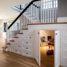 an open closet under the stairs in a house