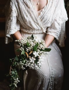 a woman holding a bouquet of flowers in her hand and the caption below reads,