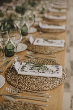 the table is set with place settings and silverware for guests to sit down at