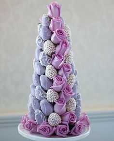 a purple and white cake with flowers on it