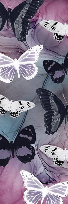 several white and black butterflies are flying in the air over purple watercolor paper sheets