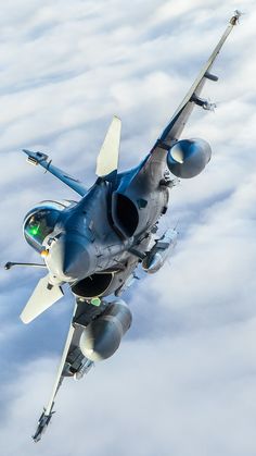 a fighter jet is flying through the clouds