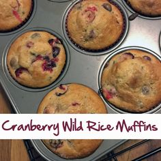 a muffin tin filled with blueberries and cranberry wild rice muffins