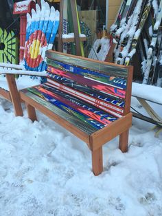 a bench made out of skis in the snow