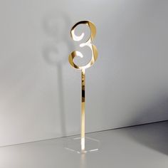 a gold cake topper with the number eight on it's side in front of a white background