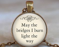 a necklace with a quote on it that says may the bridges i burn light the way