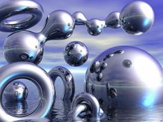 several shiny balls floating in the air next to each other on a body of water