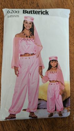 an adult and child's pink outfit with matching headbands