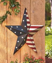 an american flag star hanging on a wooden fence