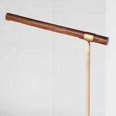 a wooden and brass desk lamp on a white background