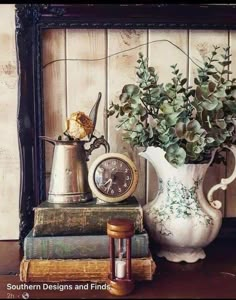 there is a vase with flowers on top of books and a clock next to it