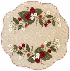 an oval shaped rug with strawberries and flowers on the border, in white background