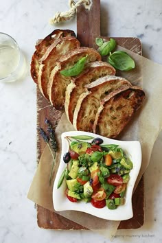 slices of bread, salad and milk on a cutting board