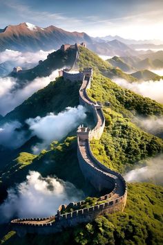 an aerial view of the great wall of china with clouds and mountains in the background